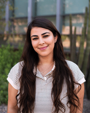 Nadia Malek smiles at the camera.